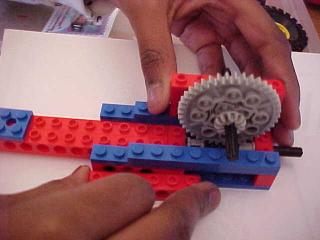 The small gears are just to center the main gear over the worm gear.