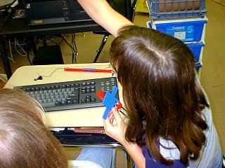 Ally showing Brenda how to build the model on LEGO CAD