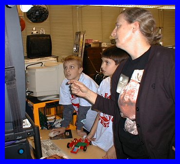 Mrs. Hamilton, Andrew, and Scott working on LEGO CAD to build the raft virtually